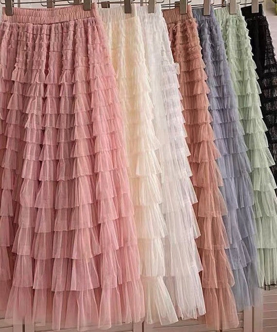 Ruffled petticoats in various colors hanging on a rack.