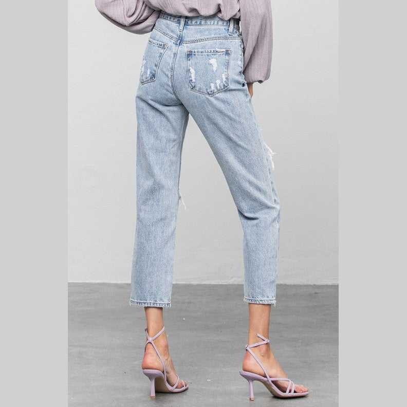 Light blue women's jeans by Denim Lab USA, perfect for travel with a comfortable fit and trendy distressed details