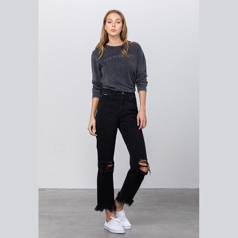 Women wearing edgy straight leg jeans with distressed details and fringed hem for a stylish look