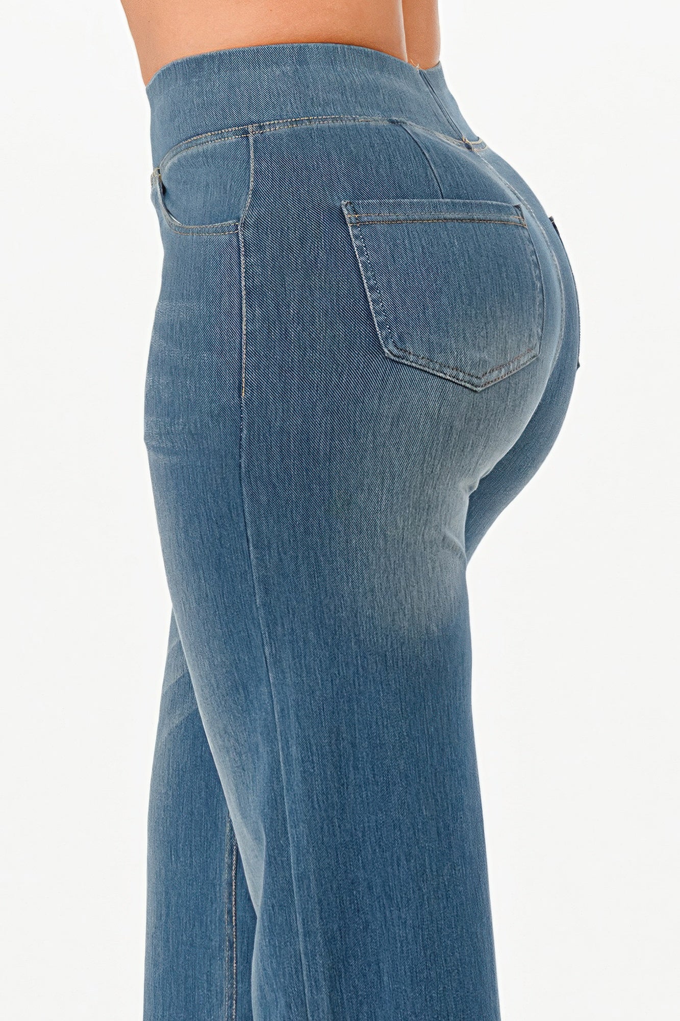 Side view of VacationGrabs ultra soft flare baggy jeans in light blue with a flattering fit