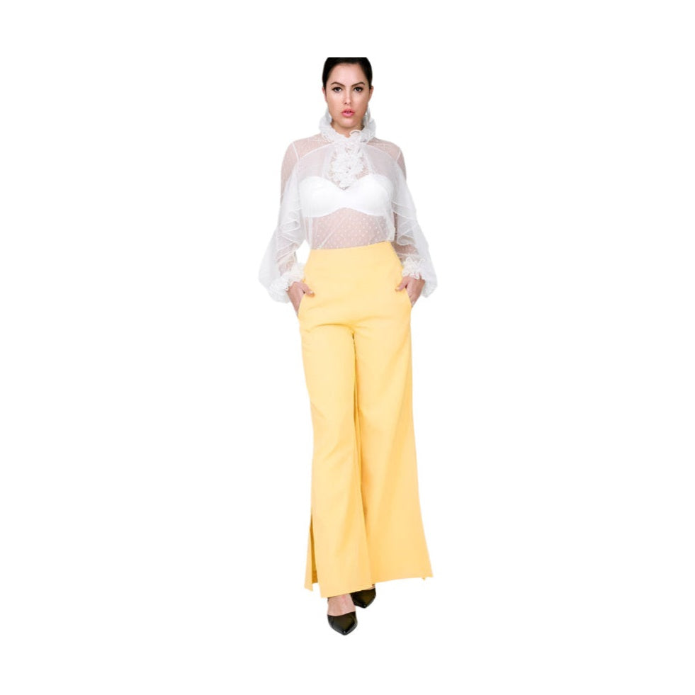 Yellow side slit trousers vacation style for women paired with sheer white blouse and black heels